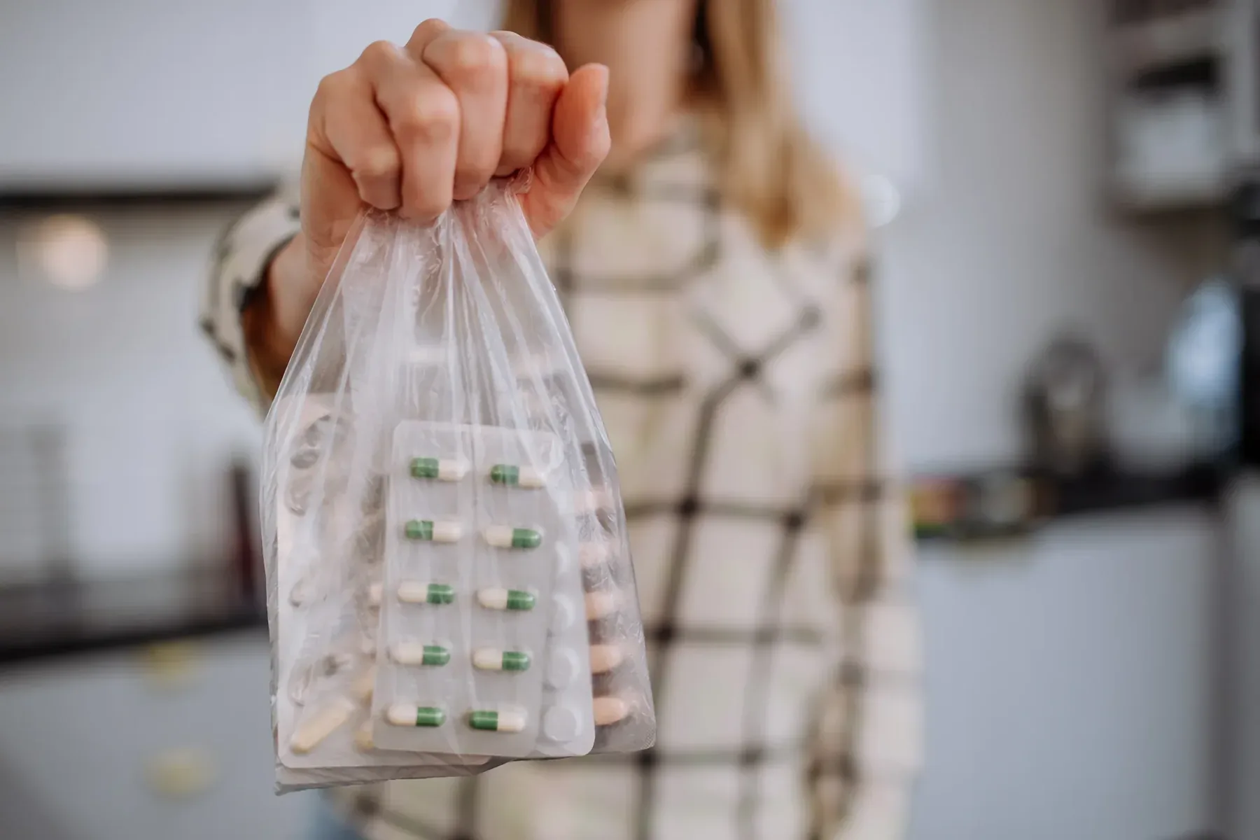 Unwanted medicines in blister packs gathered in a bag.