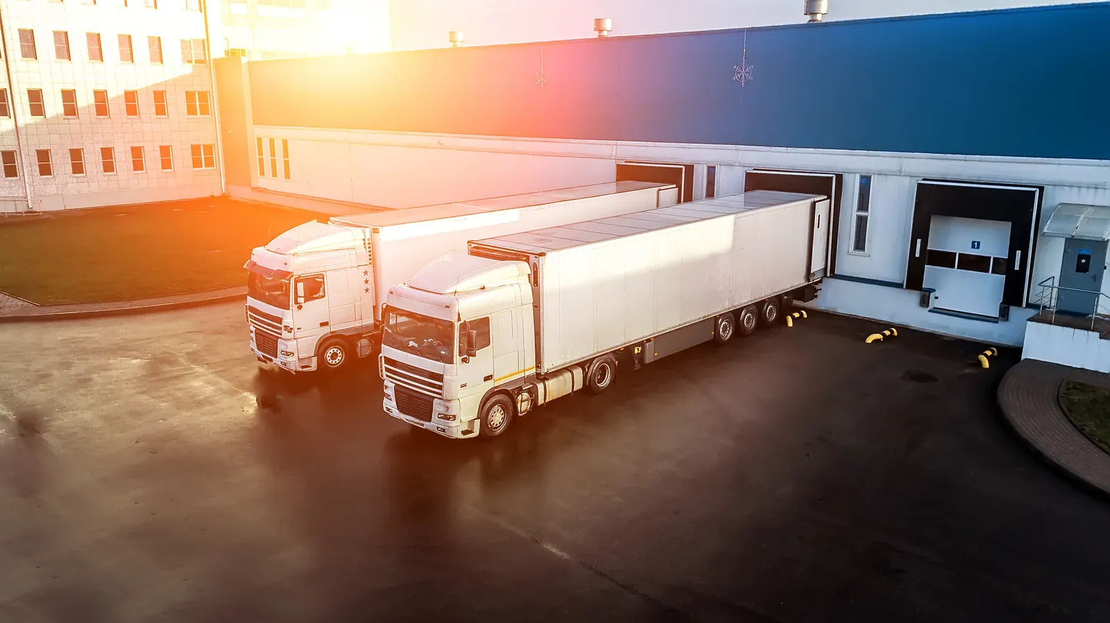 Loading bays and lorries outside a distribution warehouse.
