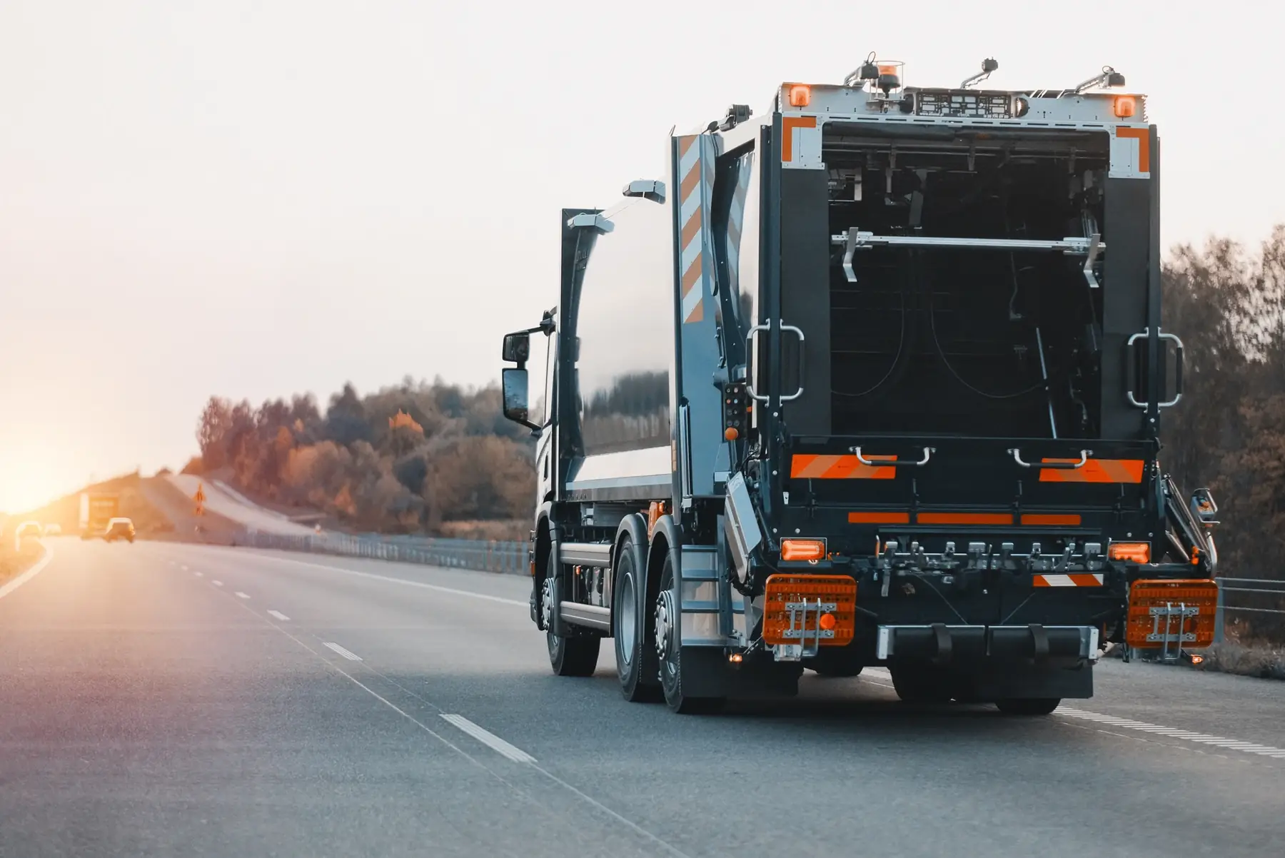 Refuse collection lorry travelling along a motorway.