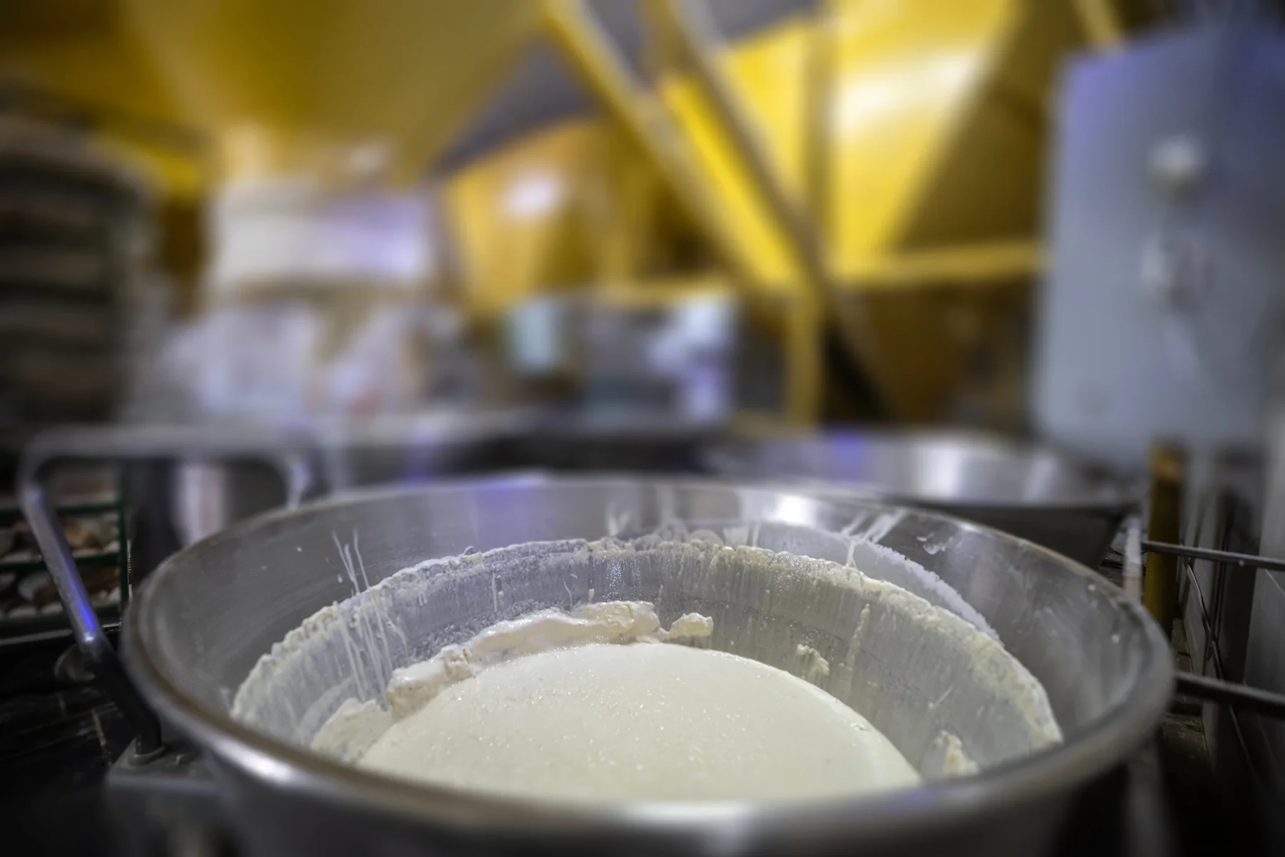 Mixing bowl and bulk ingredient equipment in a bakery.