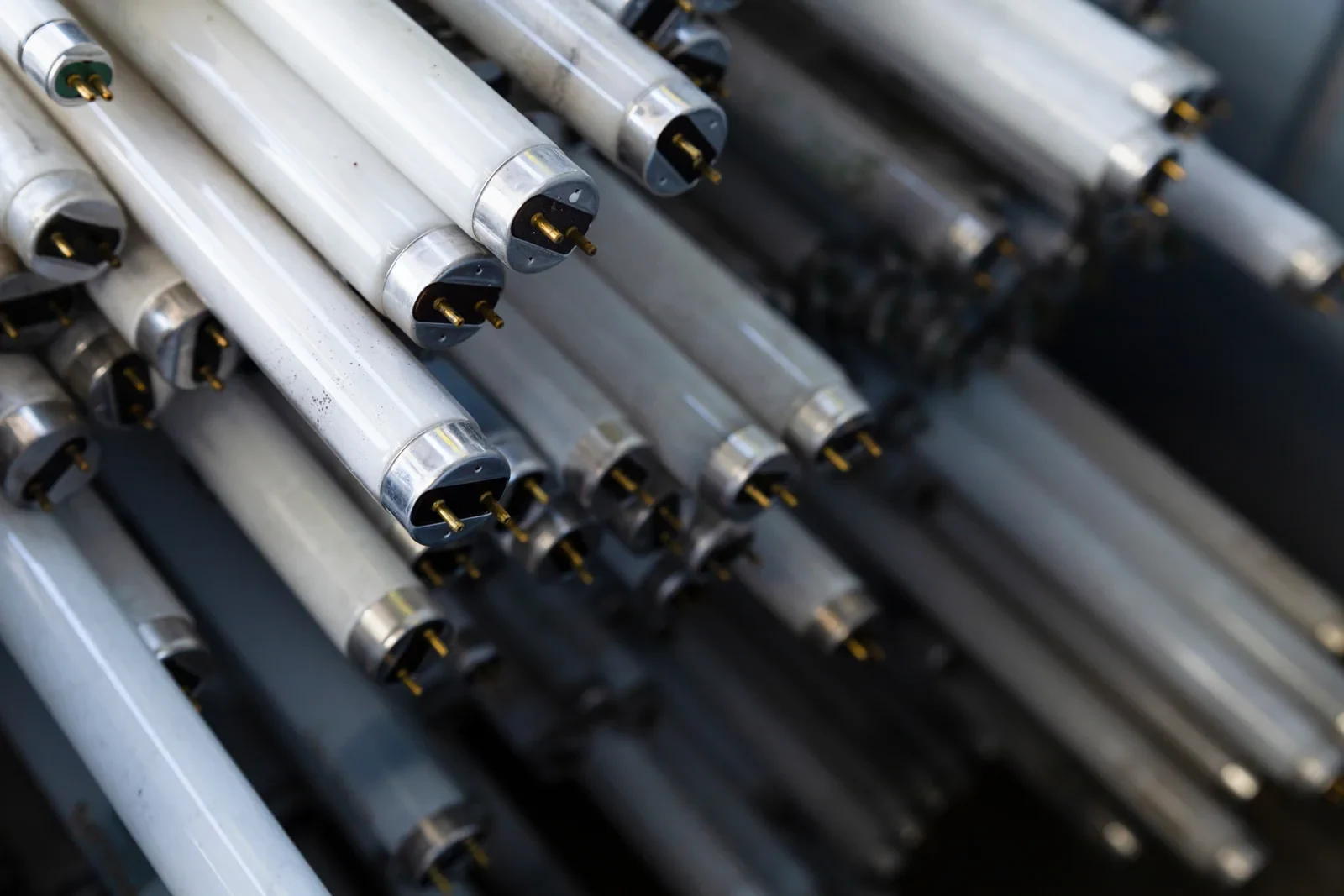 Disused fluorescent light tubes stacked together.